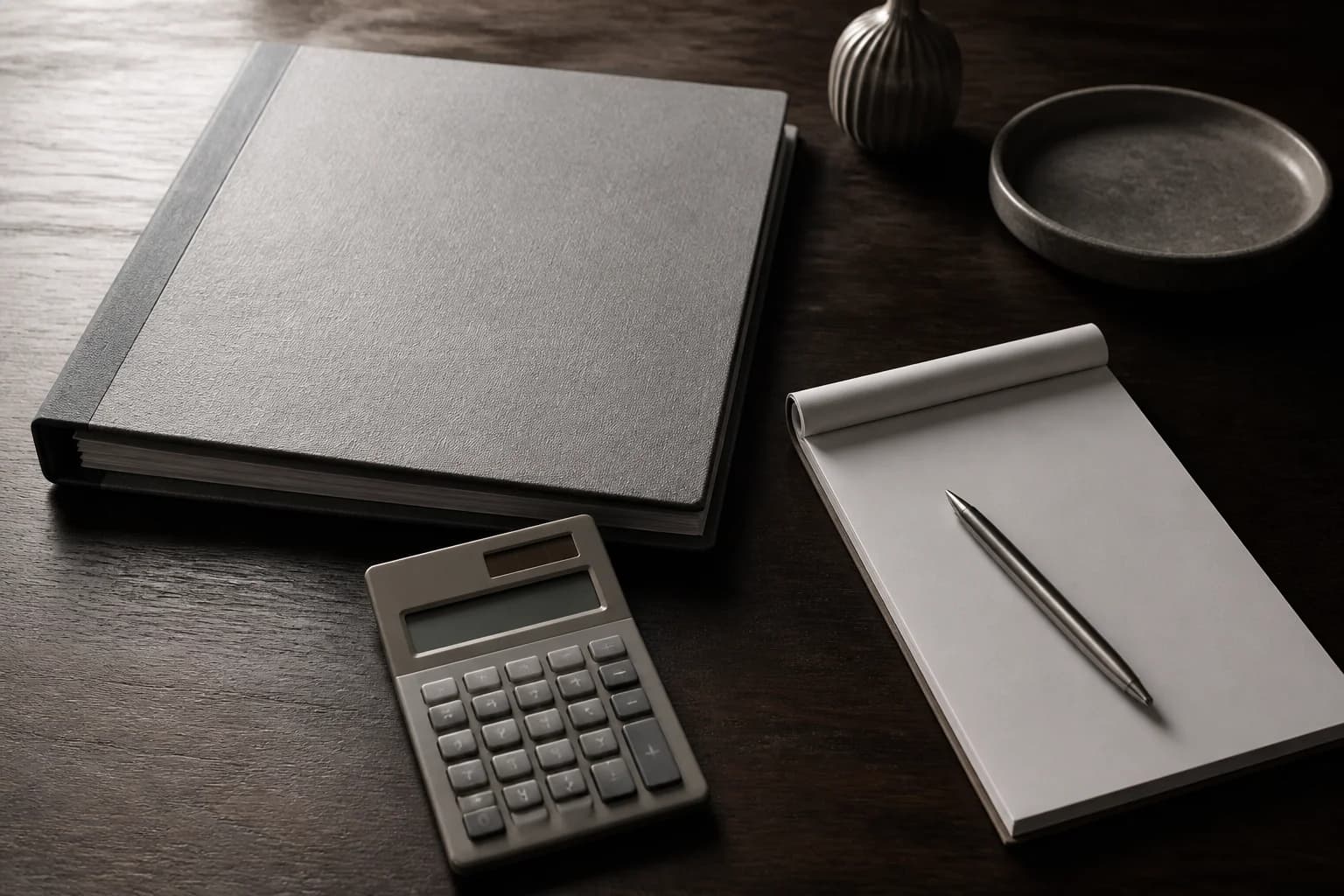 Two unlabeled columns of paper on a zinc desk, the closing table for a buyout